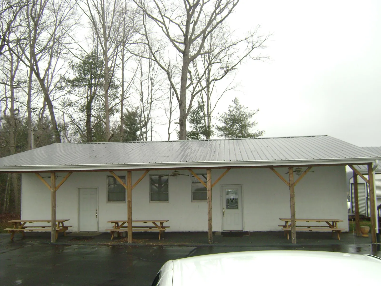Gray metal roof over a block building with a timber post porch in Parkers Lake